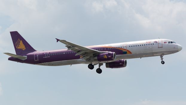 A Cambodia Angkor Air Airbus A321 flying against a clear sky, showcasing aviation dynamics.