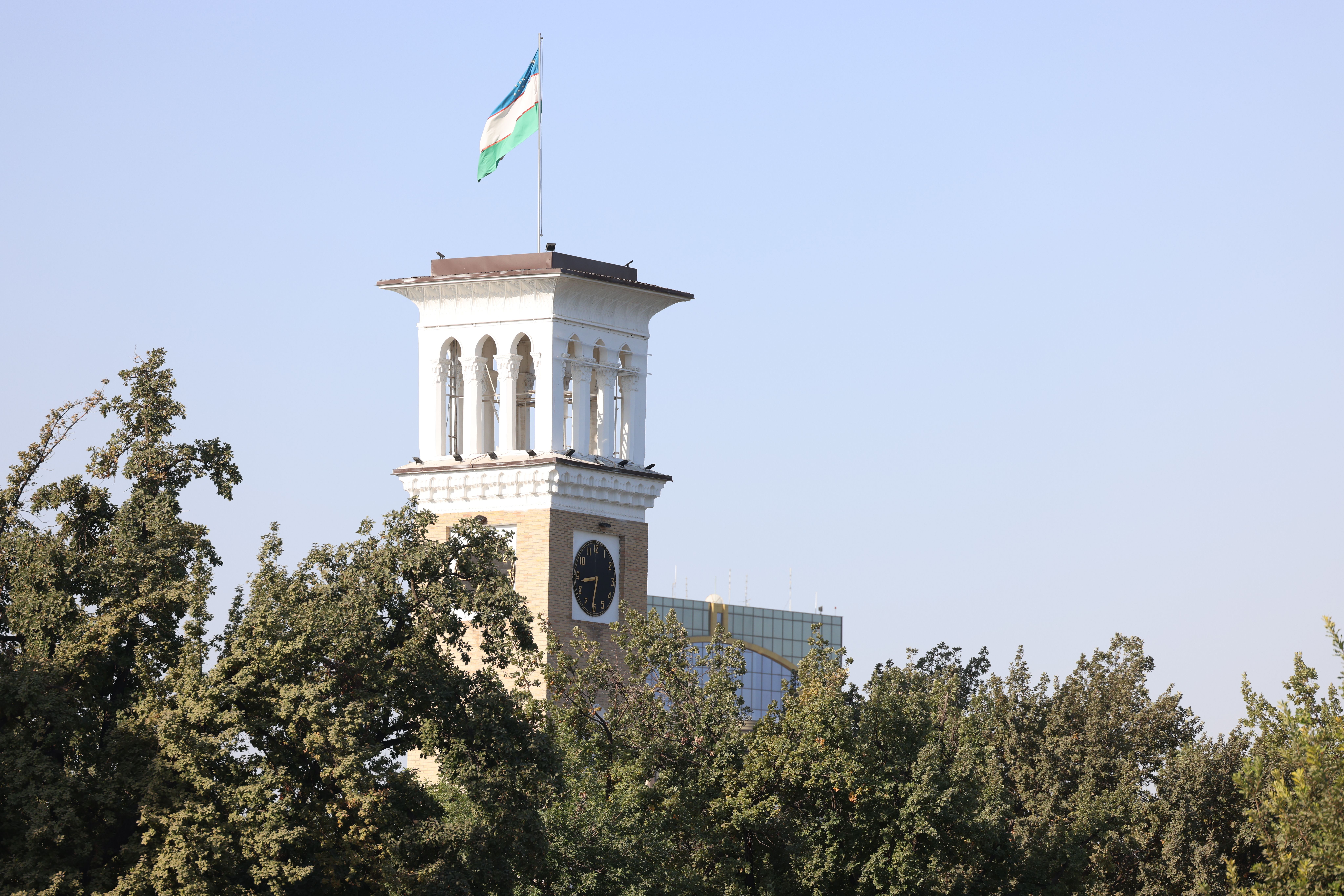 A scenic view of the iconic clock tower in Tashkent, showcasing classic architecture against a clear sky.