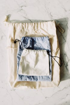 Aesthetic arrangement of reusable fabric pouches in natural light, showcasing sustainable living.