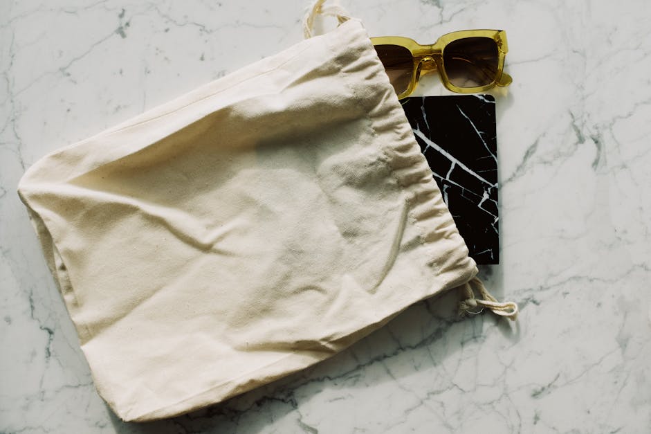 Notepad and sunglasses with cotton bag · Free Stock Photo