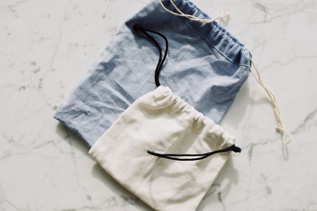 Two canvas drawstring pouches on a marble surface, photo by ready made on Pexels