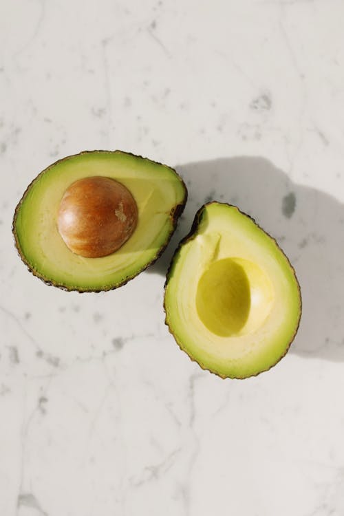 Sliced Avocado Fruit On White Surface