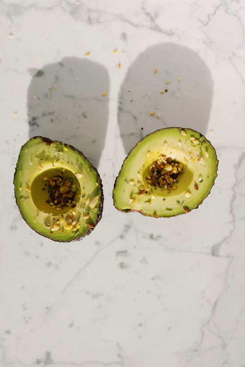 Sliced Avocado Fruit on White Surface