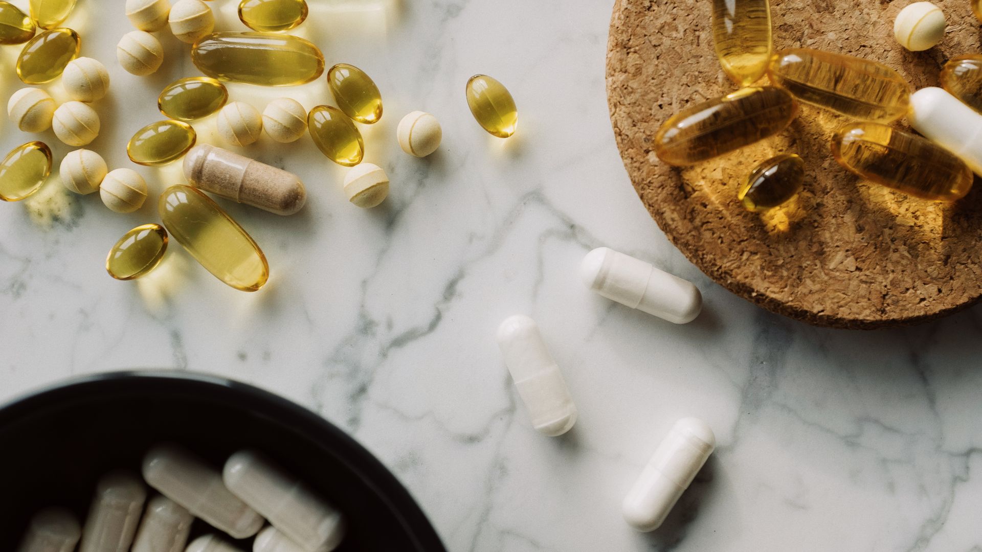 Natural Nootropics vs Synthetic: Understanding the Key Differences Flat lay of various capsules and pills on marble for healthcare and medication concept — natural nootropics vs synthetic