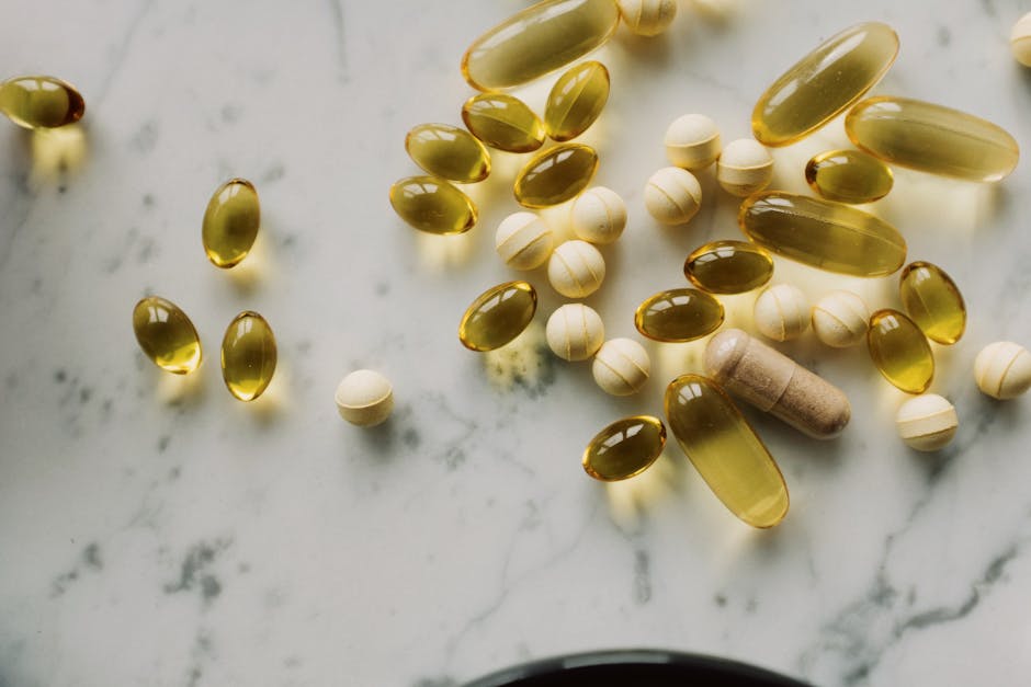 Why Popular Supplement Myths Persist — What Science Says Variety of supplements and capsules scattered on a marble surface, suitable for healthcare themes.