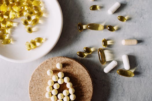 Variety of capsules and pills arranged on a marble surface. Healthcare and medicine theme.