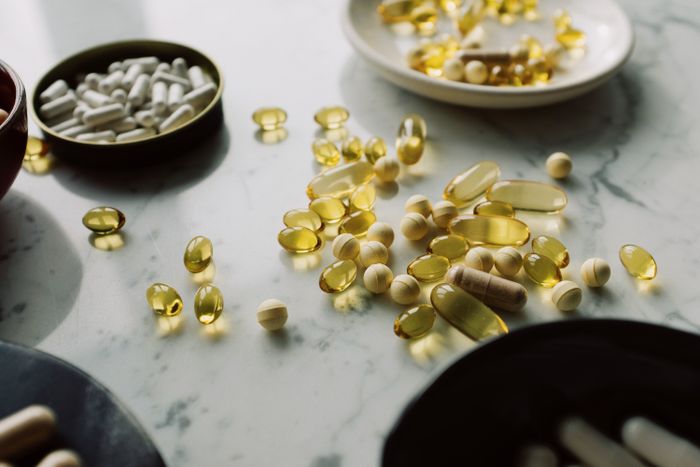 Assorted supplement capsules on a marble counter - photo by ready made on Pexels
