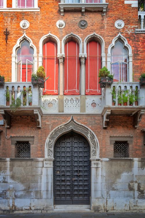 Free Elegant Venetian Gothic facade in Venice with red windows and ornate details. Stock Photo