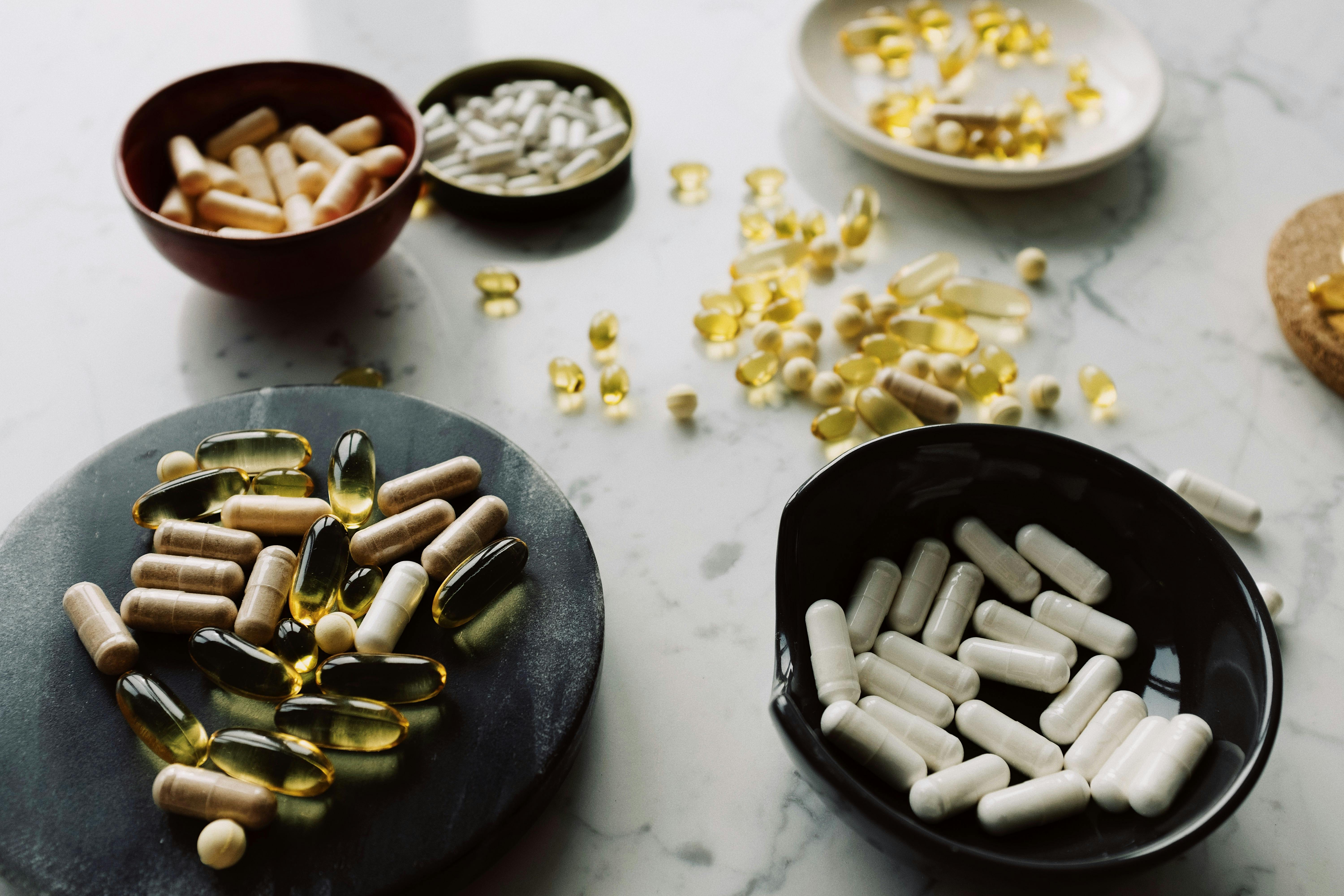 various bowls and stands with vitamins on white desk