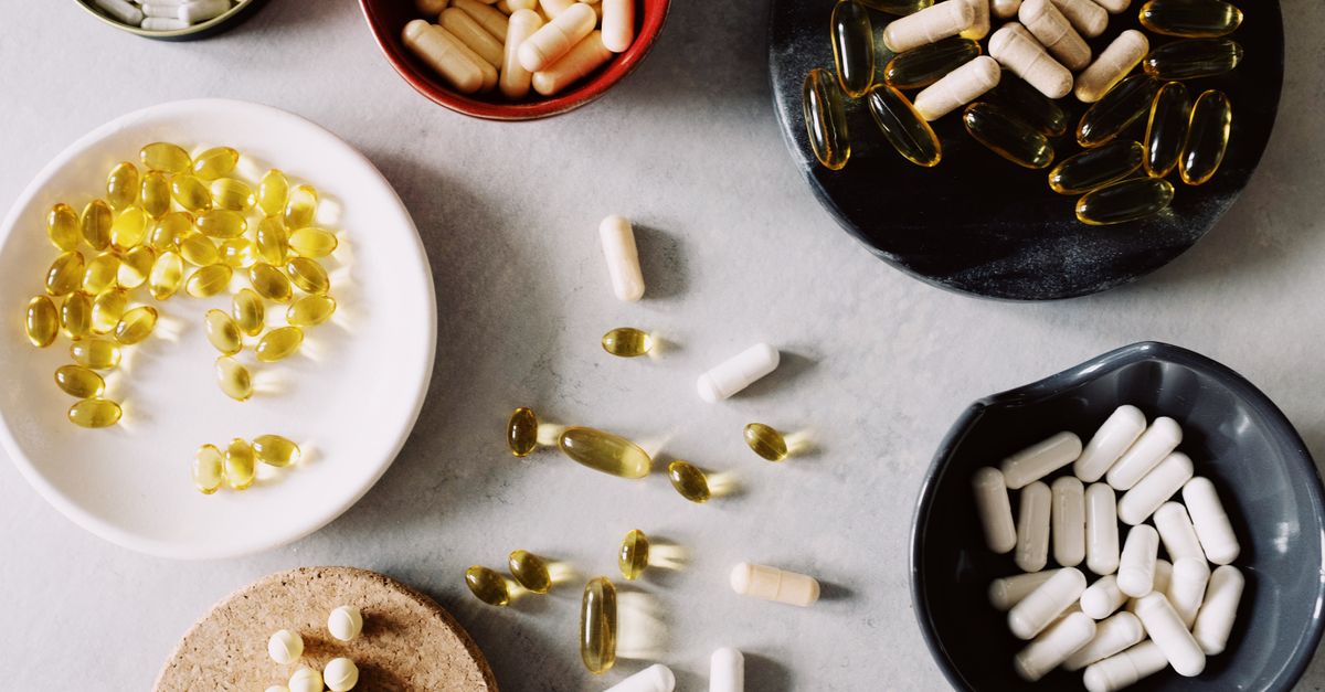 Various pills and supplements in bowls on a marble surface, ideal for healthcare contexts. - Evidence evidence guide for vitamin K2 calcium metabolism meta-analysis