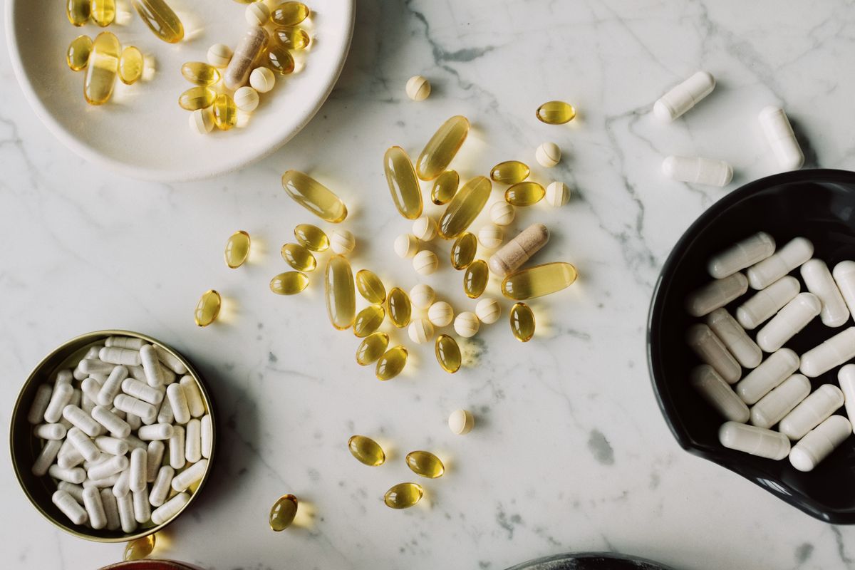 Supplement bottles and protein powder on a clean counter — supplements for women over 40