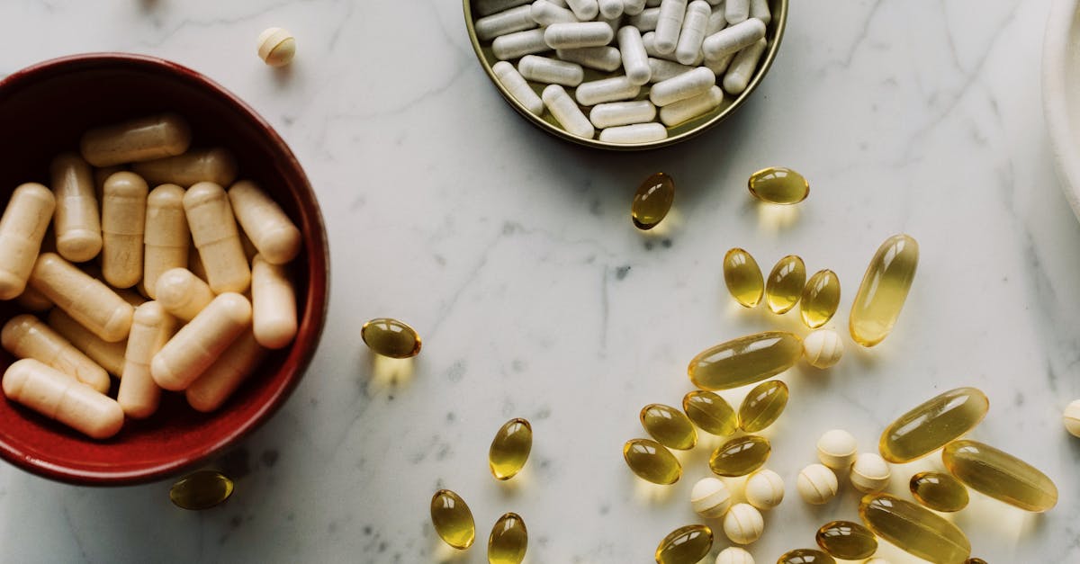 Top view of various supplements and capsules arranged on a marble surface with ample copy space. Top view of various supplements and capsules arranged on a marble surface with ample copy space.