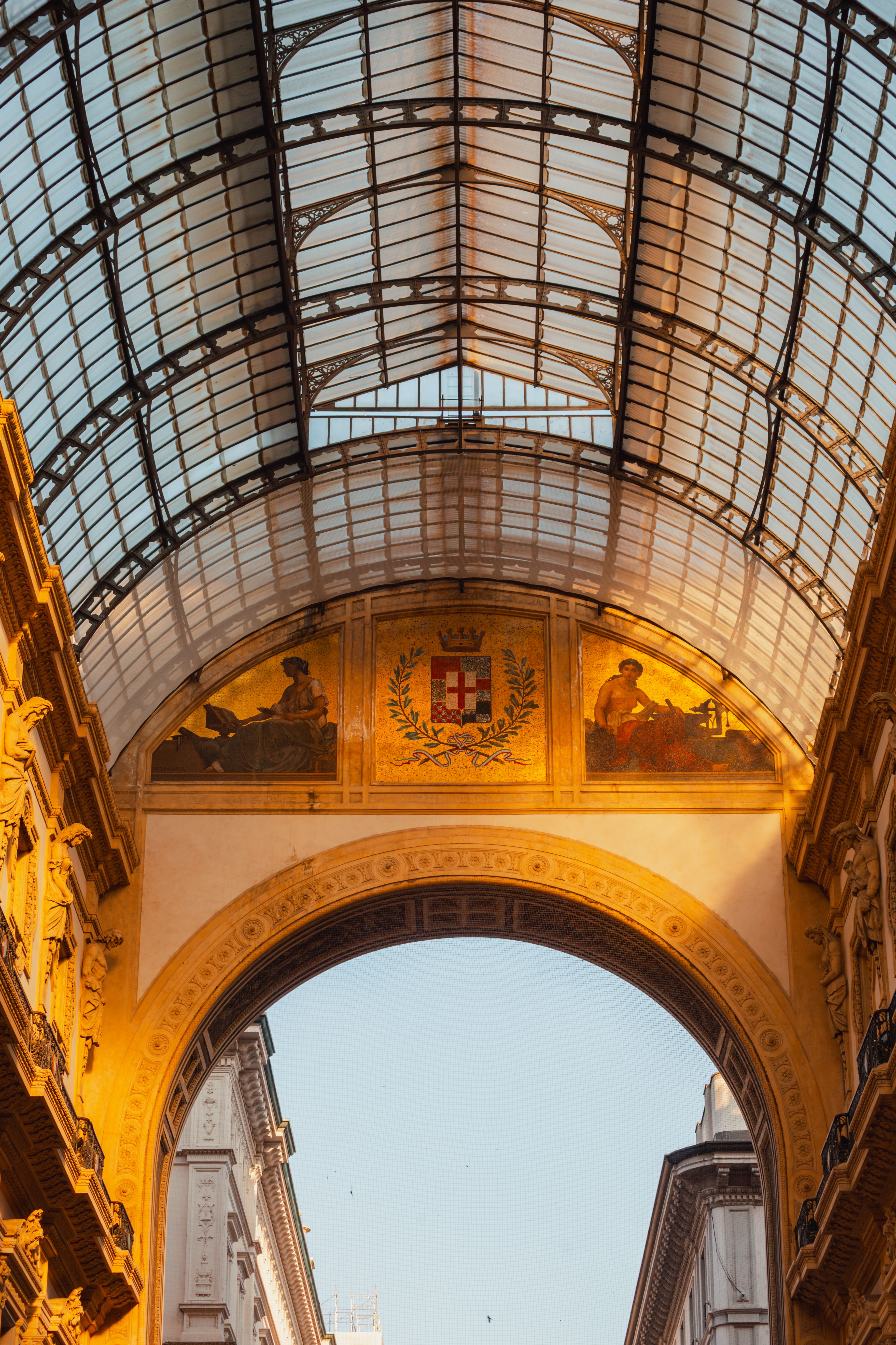 Elegant architecture of Galleria Vittorio Emanuele II in Milan during sunset, capturing its grandeur and historical charm.