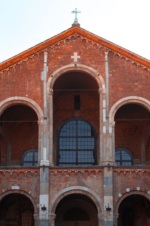 Free Red brick facade of the historic Basilica di Sant'Ambrogio in Milan, showcasing Romanesque architecture. Stock Photo