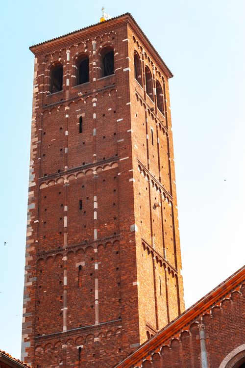 Free Stunning view of a historic brick bell tower in Milan, Italy, under a clear blue sky. Stock Photo