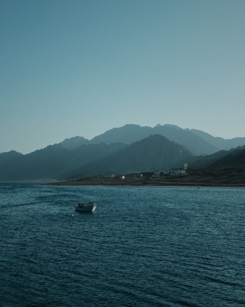 Free Twilight view of a tranquil seaside along Dahab's coastline in Egypt showcasing a quiet landscape. Stock Photo