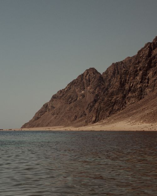 Free A breathtaking view of the coastal cliffs in Dahab, South Sinai, Egypt under a moody twilight sky. Stock Photo