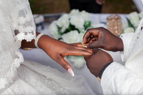 Free Close-up of bride and groom exchanging rings during a wedding ceremony, symbolizing love and commitment. Stock Photo