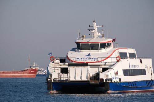 Free Ferry sailing on the Aegean Sea in Izmir, Türkiye. Modern transportation in coastal cityscape. Stock Photo