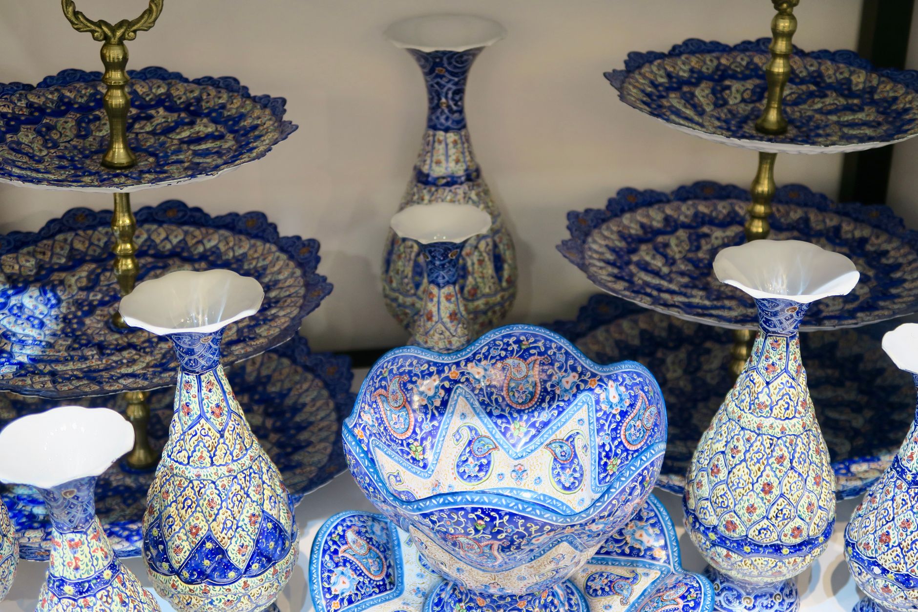 A colorful display of traditional Persian ceramic vases and plates with intricate designs.