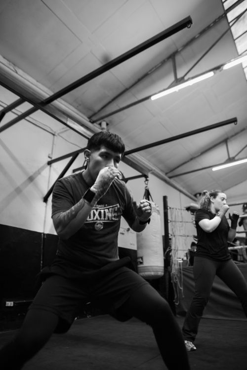 Free Engaging indoor boxing class in Buenos Aires with adults training intensely. Stock Photo