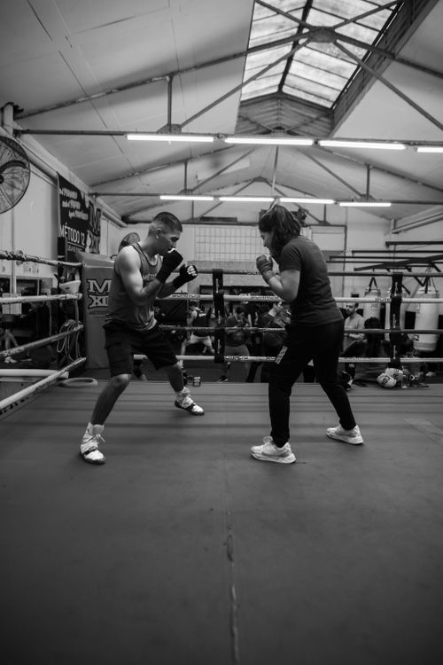 Free Two boxers sparring in a Buenos Aires gym, captured in a dynamic black and white photo. Stock Photo