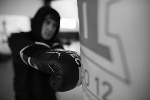 Free Boxer practicing punches on a bag in a gym in Buenos Aires. Stock Photo