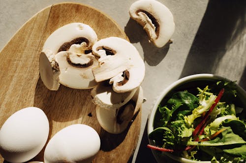 Free Sliced Mushrooms On Brown Wooden Chopping Board Stock Photo
