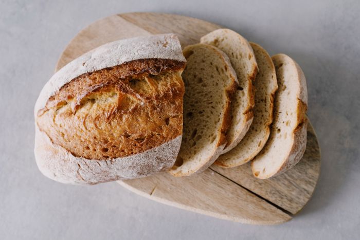 Freshly sliced artisan bread on a rustic wooden board