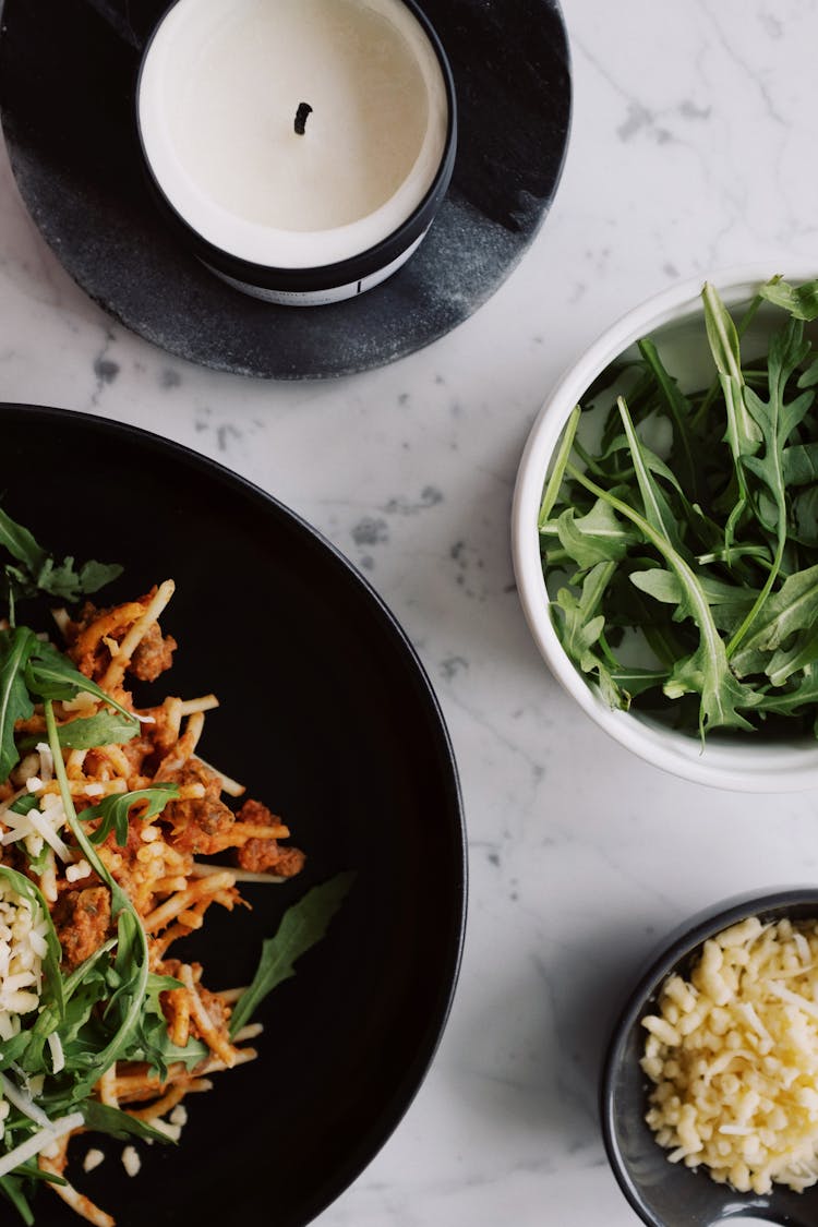 Plate With Spaghetti Bolognese Arugula And Cheese