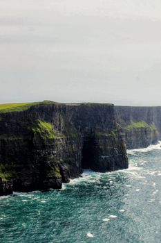 Majestic aerial view of the Cliffs of Moher, showcasing Ireland's rugged coastal landscape.