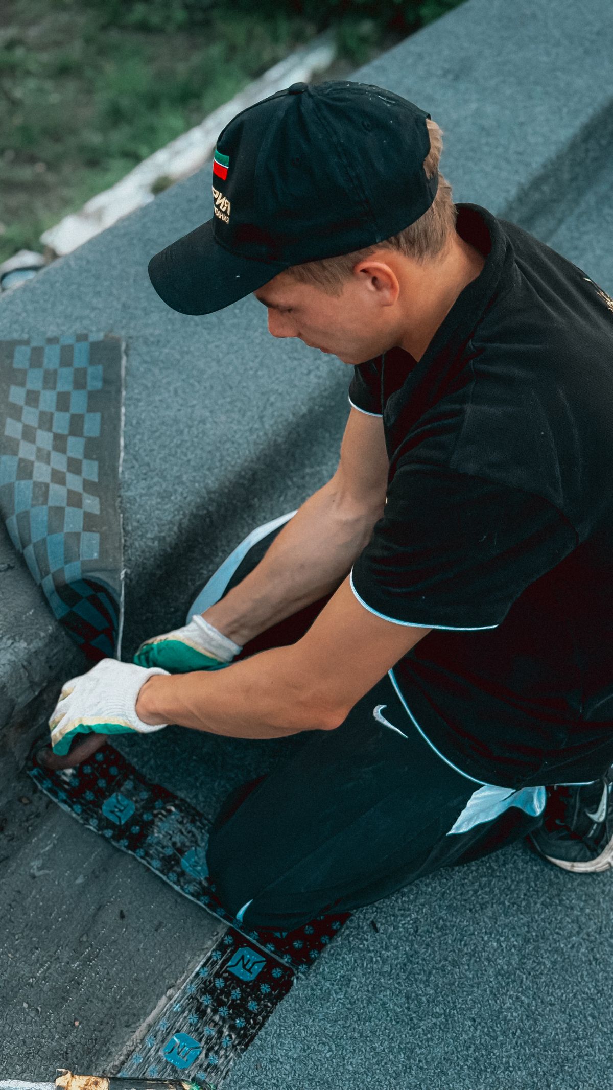roofer applying shingles on a flat roof
