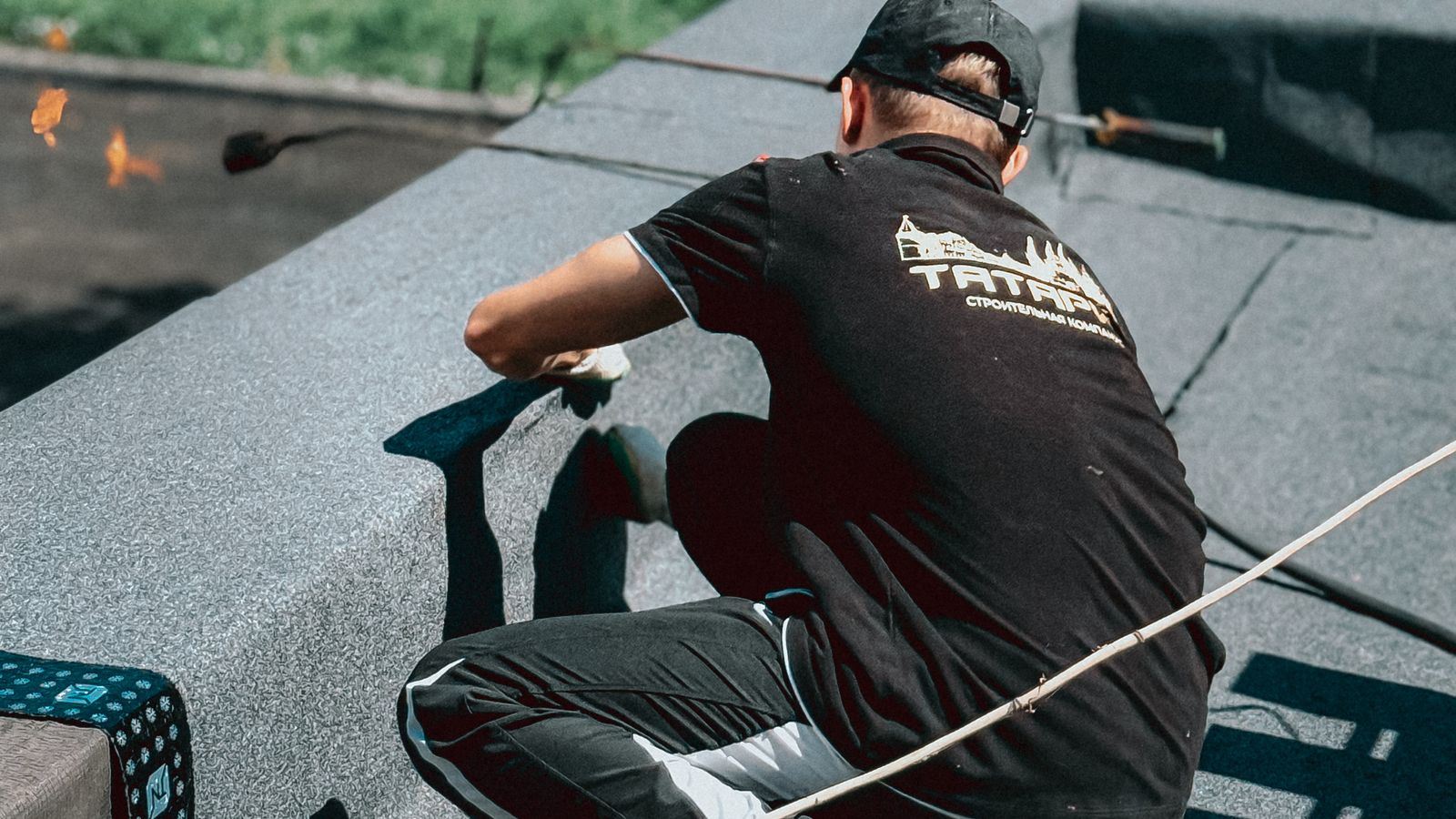 Roofer working on a flat roof in daylight