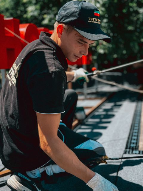 Worker carrying out a rooftop installation