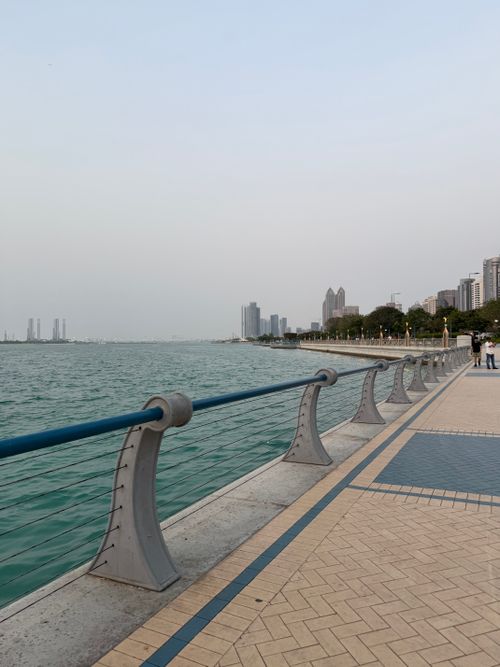 Free Scenic view of Abu Dhabi Corniche with skyscrapers and waterfront promenade Stock Photo