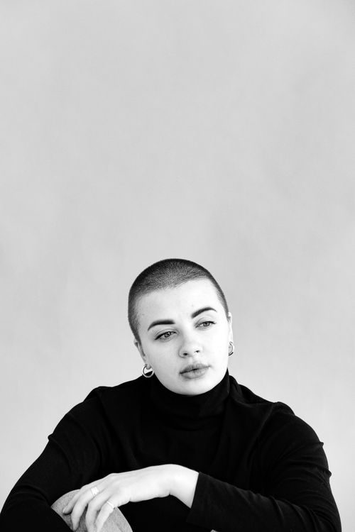 Free A striking black and white portrait of a young woman with a contemplative expression, embracing minimalist style. Stock Photo