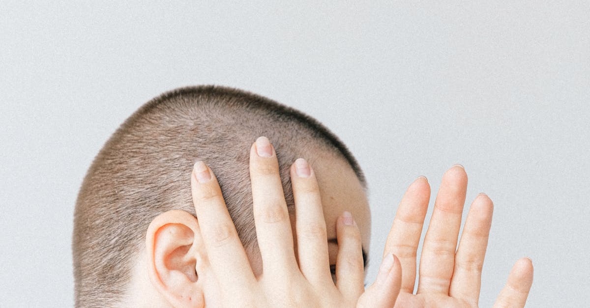 Crop person covering face with hands