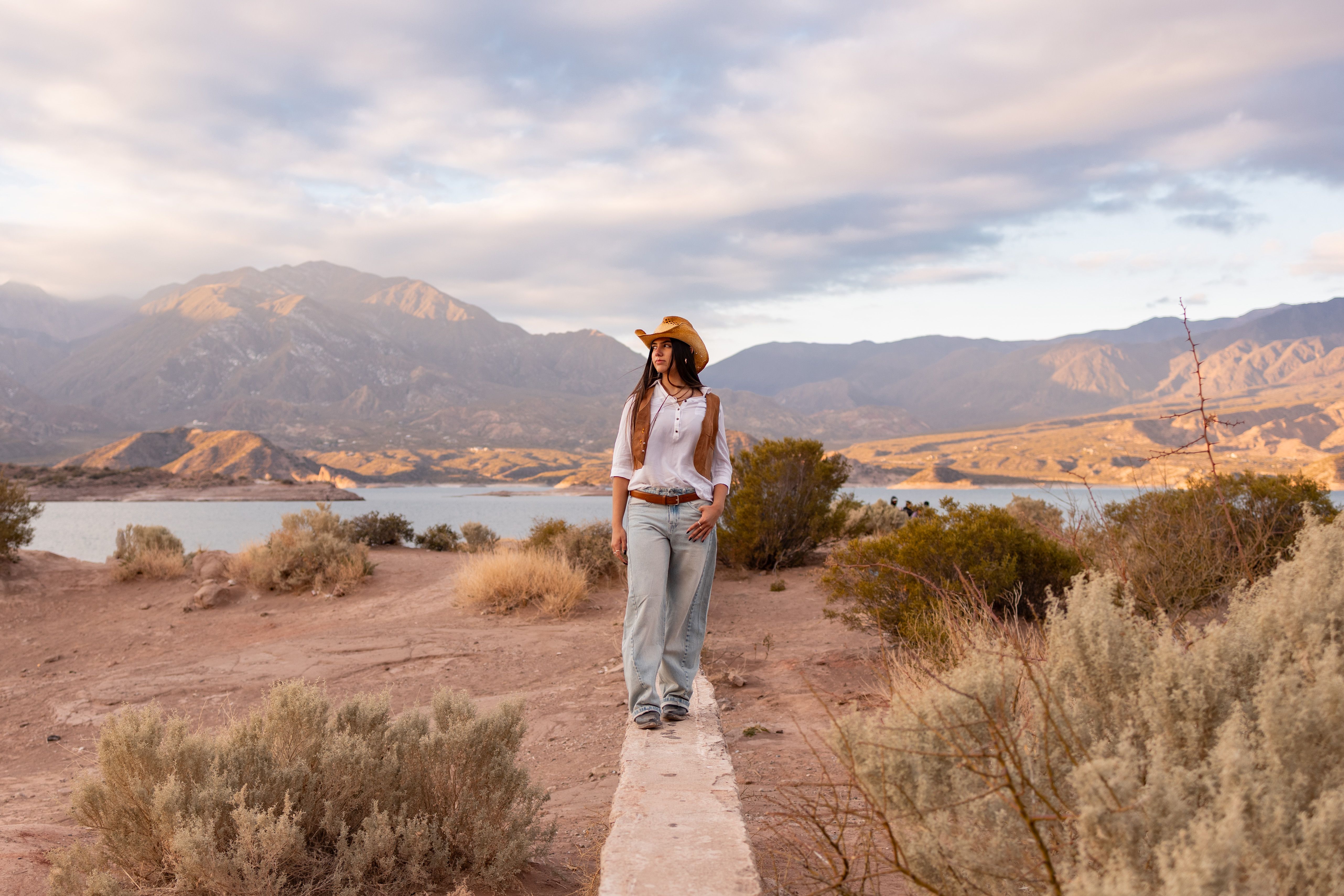 A serene scene of a woman walking in the picturesque landscape of Mendoza, Argentina.