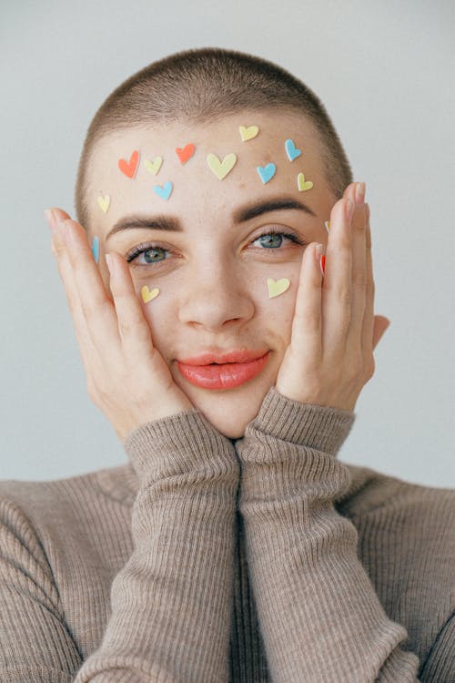 Free Young positive woman with many stickers on face Stock Photo