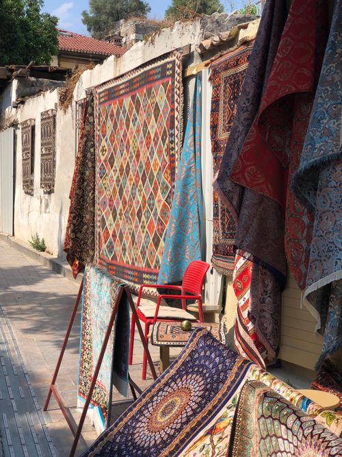 Free A vibrant display of traditional Turkish rugs hanging outside in Antalya's historic town center. Stock Photo