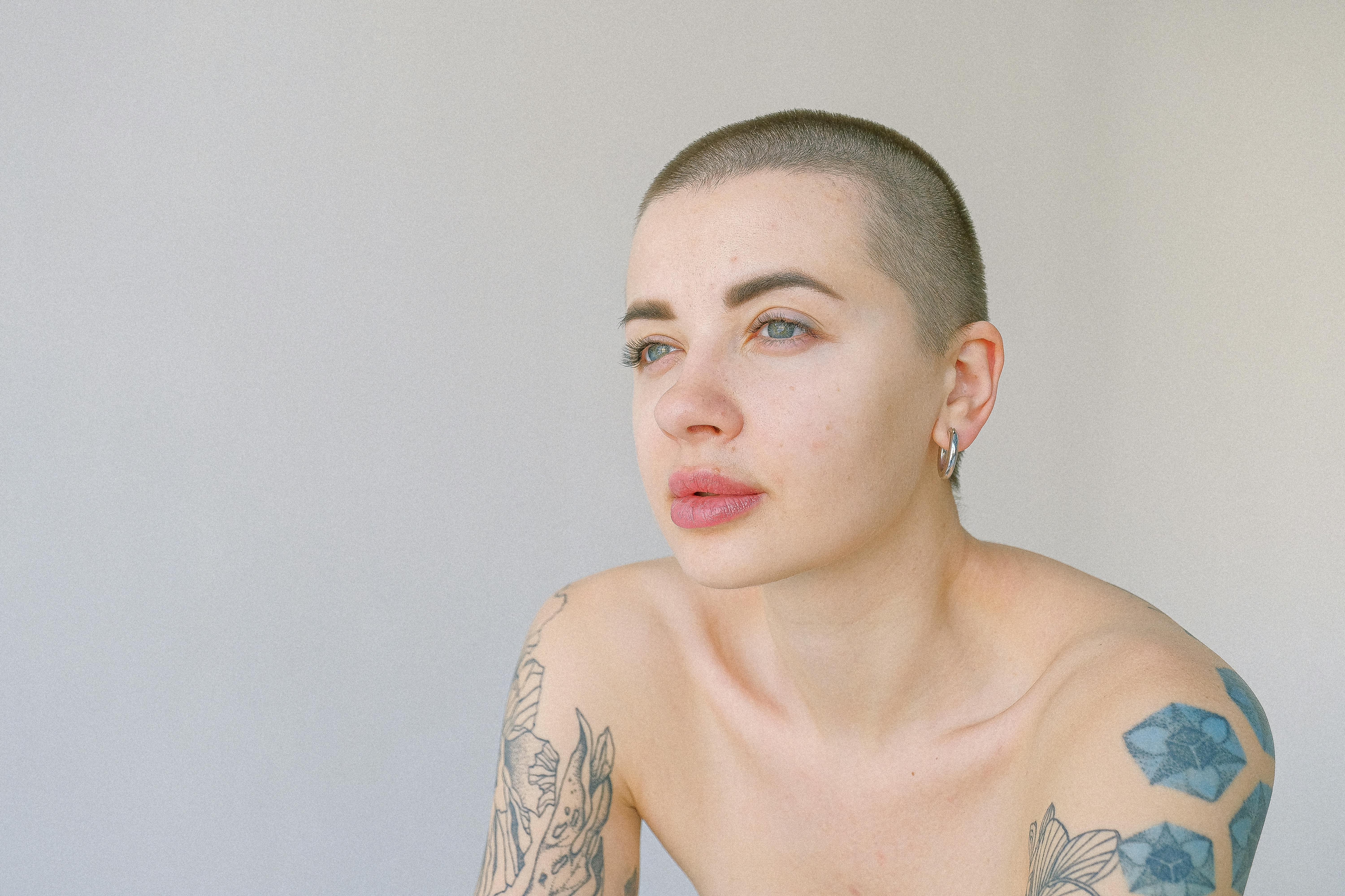 woman with black and white floral tattoo on her shoulder