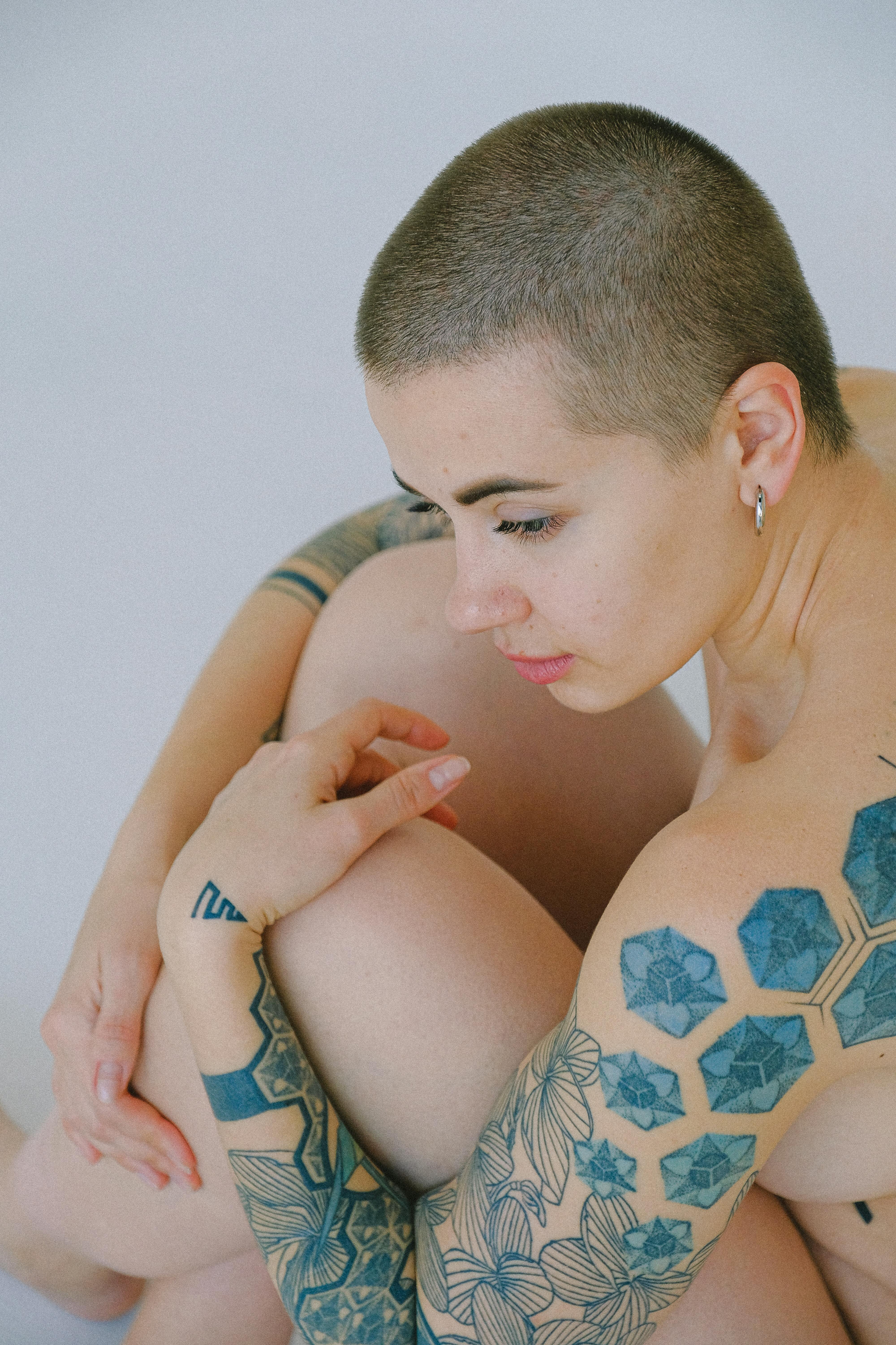 Tattooed nude woman with short hair · Free Stock Photo