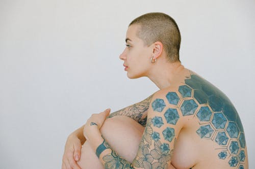 Free Topless Woman With Tattoo On Her Right Arm Stock Photo