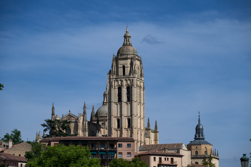 Free Majestic Segovia Cathedral tower in Spain rising against a clear blue sky. Stock Photo