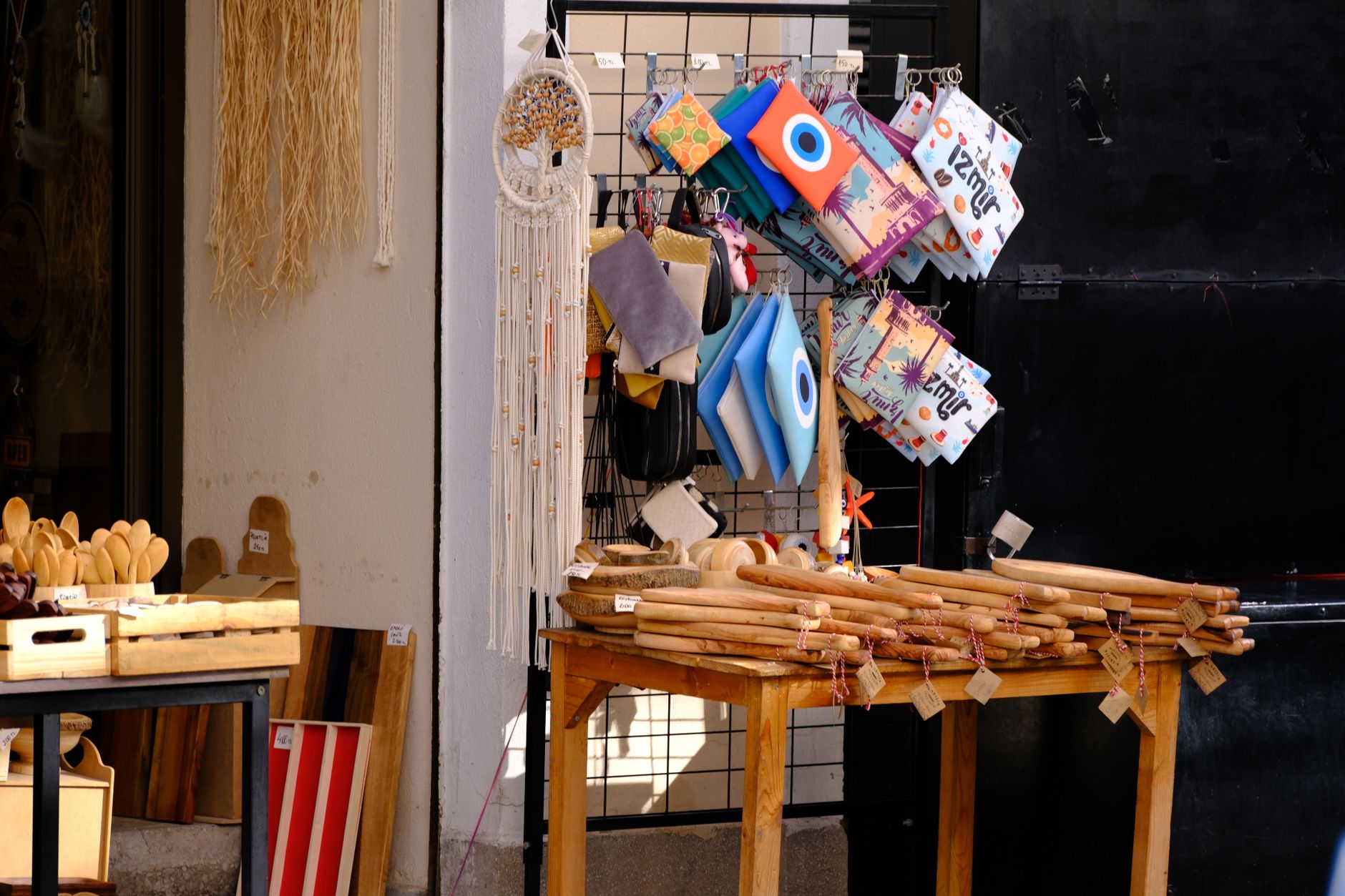 A vibrant market stall in İzmir showcasing traditional crafts, bags, and decorations.