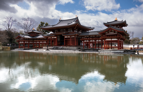 Free Scenic view of Byodoin Temple reflecting on a pond under a dramatic spring sky in Uji, Kyoto, Japan. Stock Photo