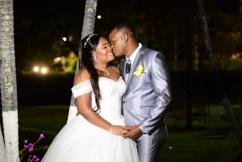 Free A bride and groom share a loving kiss outdoors during their night wedding ceremony. Stock Photo