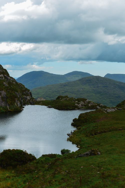 Free Beautiful mountainous landscape in Ireland with serene lake and cloudy sky. Stock Photo