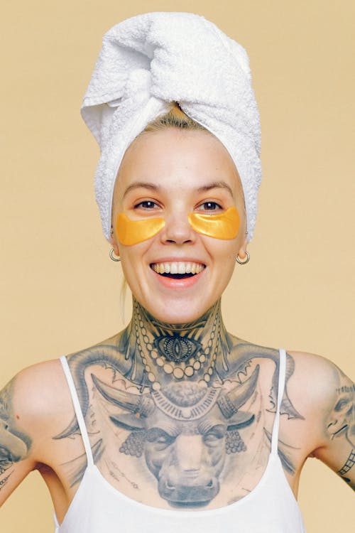 Cheerful female with tattoos in eye patches