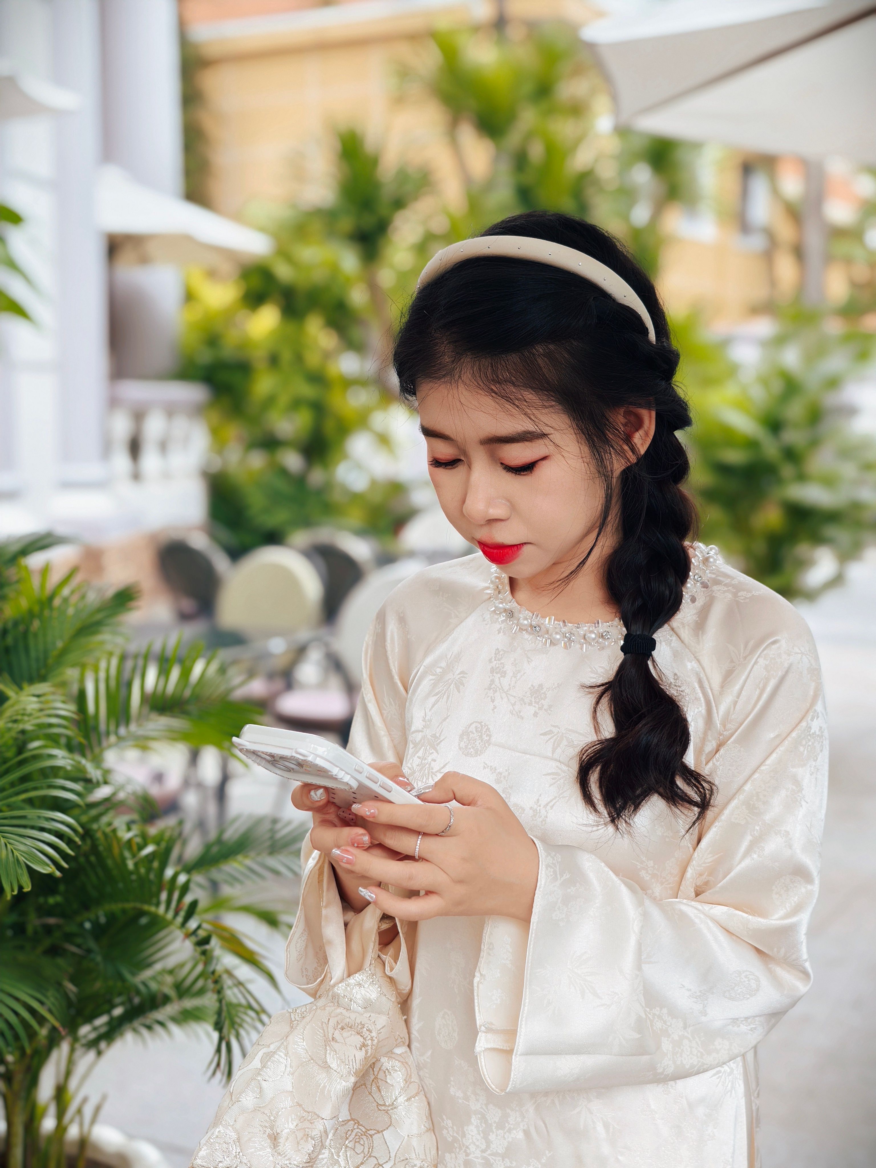 Young Woman in Traditional Dress Using Smartphone